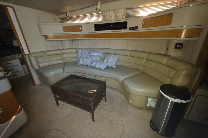 Slide: The Image of Interior of 1991 Sea Ray 420 Sundancer with curved leather seating and striped cushions. - 26
