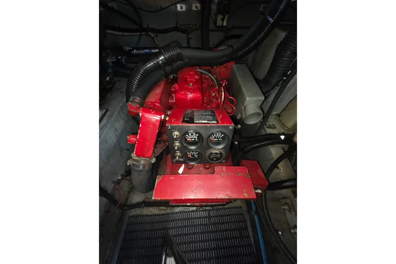 Slide: The Image of Engine compartment of a 1991 Sea Ray 420 Sundancer with red machinery and gauges. - 32