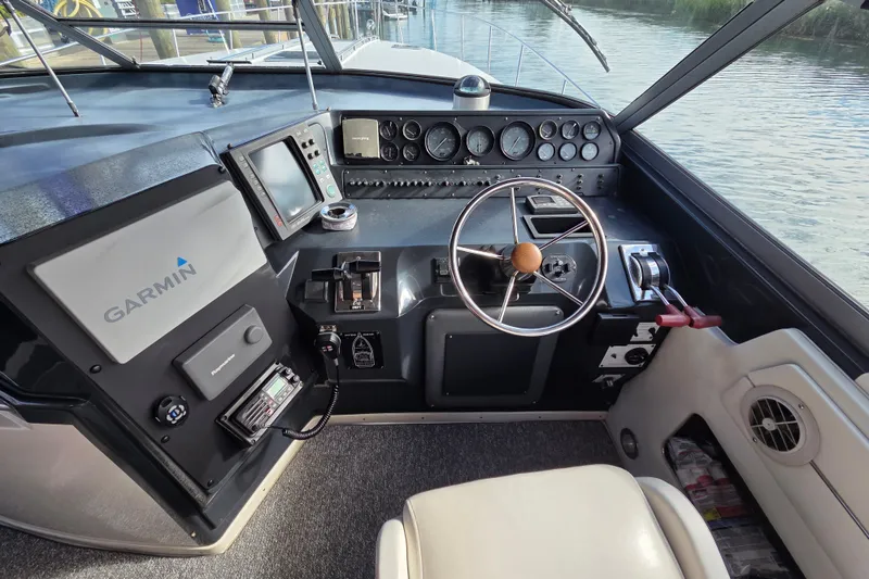 Slide: The Image of Cockpit of 1991 Sea Ray 420 Sundancer with Garmin navigation system and steering wheel. - 15