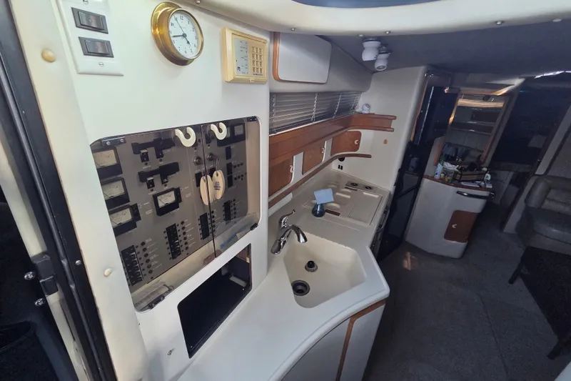 Slide: The Image of Interior of 1991 Sea Ray 420 Sundancer yacht, featuring kitchen and control panel. - 21