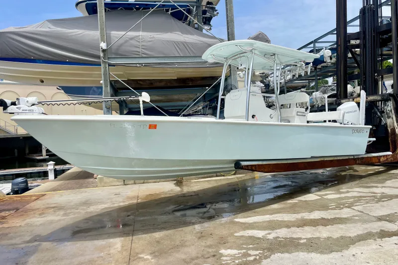 Slide: The Image of 2022 Dorado 25 FD boat on lift at marina, side view. - 2