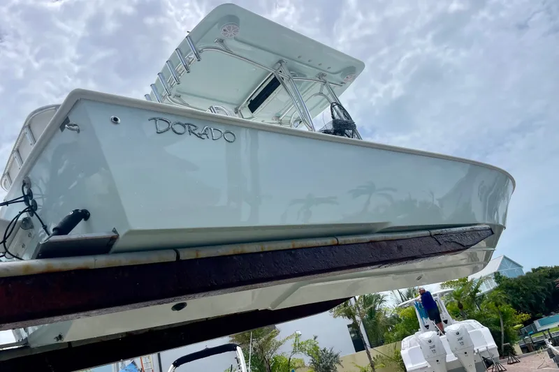 Slide: The Image of 2022 Dorado 25 FD boat on lift, showcasing sleek design and modern features. - 13