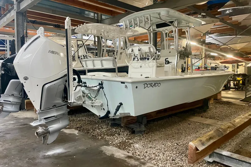 Slide: The Image of 2022 Dorado 25 FD boat with Mercury outboard engine in a storage facility. - 29