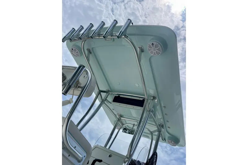 Slide: The Image of 2022 Dorado 25 FD boat's T-top with rod holders and speakers against a cloudy sky. - 20