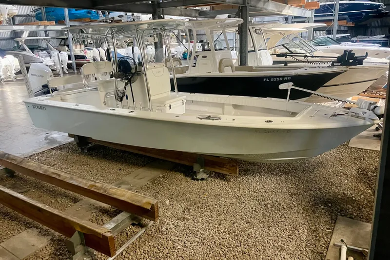 Slide: The Image of 2022 Dorado 25 FD boat in storage, featuring sleek design and Mercury engine. - 31