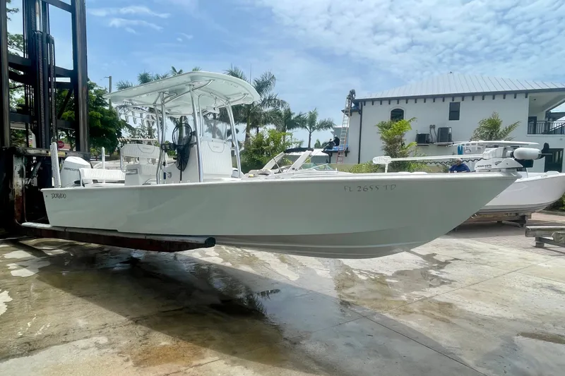 Slide: The Image of 2022 Dorado 25 FD boat on a lift, with a clear sky background. - 12
