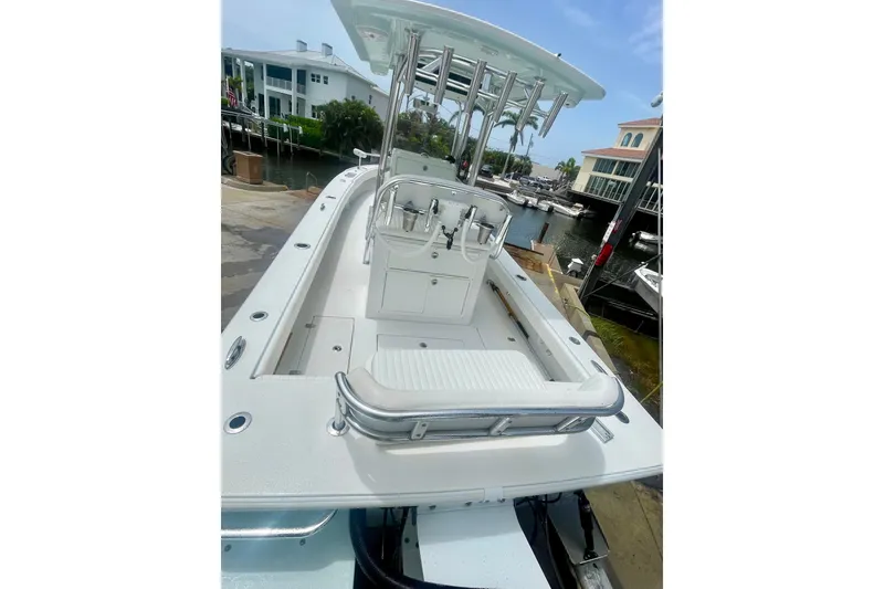 Slide: The Image of The image shows a 2022 Dorado 25 FD boat with a spacious deck and a T-top. - 15