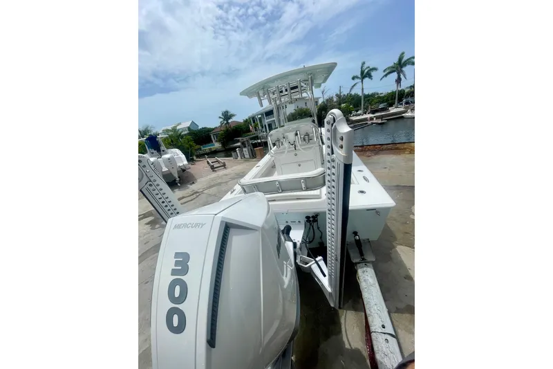 Slide: The Image of 2022 Dorado 25 FD boat with Mercury 300 engine docked near palm trees. - 8