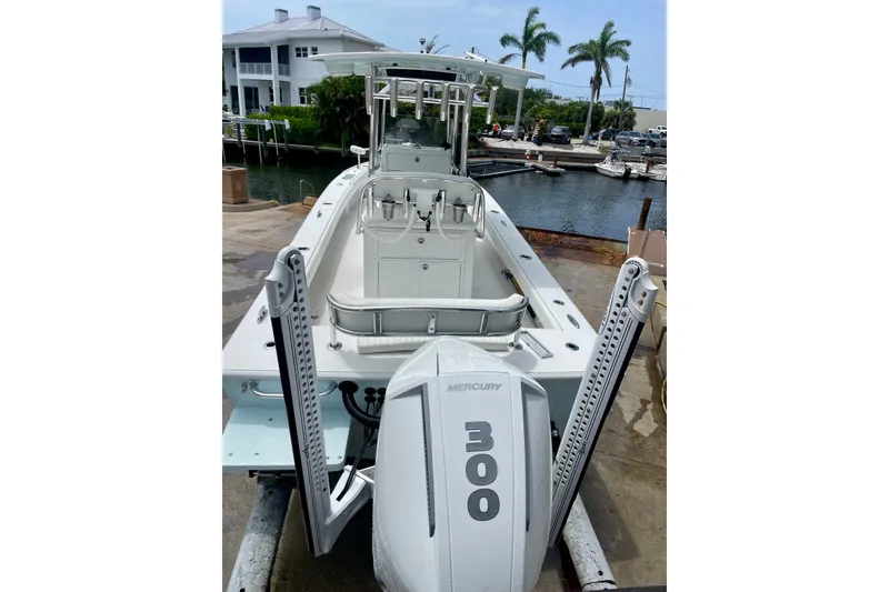 Slide: The Image of 2022 Dorado 25 FD boat with Mercury 300 engine docked near waterfront homes. - 10