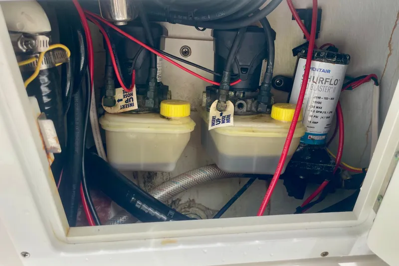 Slide: The Image of Interior view of a 2022 Dorado 25 FD boat showing wiring and fluid containers. - 27