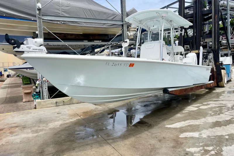 Slide: The Image of 2022 Dorado 25 FD boat on forklift at marina, side view. - 3