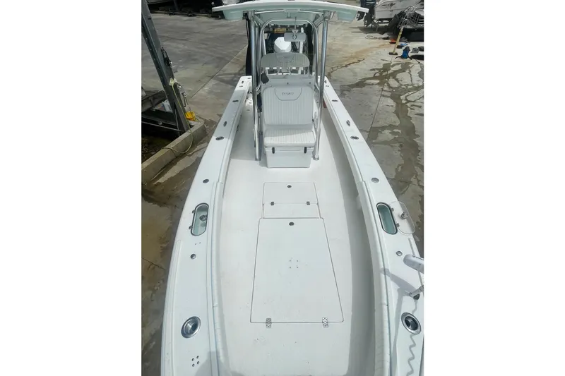 Slide: The Image of 2022 Dorado 25 FD boat with spacious deck and center console, docked at marina. - 16