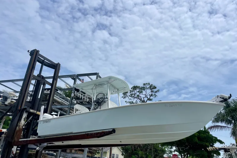 Slide: The Image of 2022 Dorado 25 FD boat on lift under cloudy sky. - 14