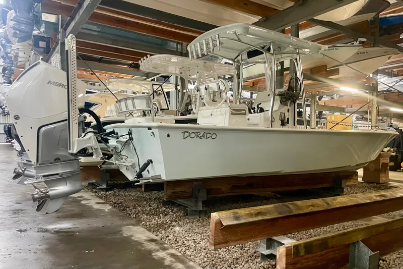 Slide: The Image of 2022 Dorado 25 FD boat in storage, featuring a Mercury outboard motor. - 33