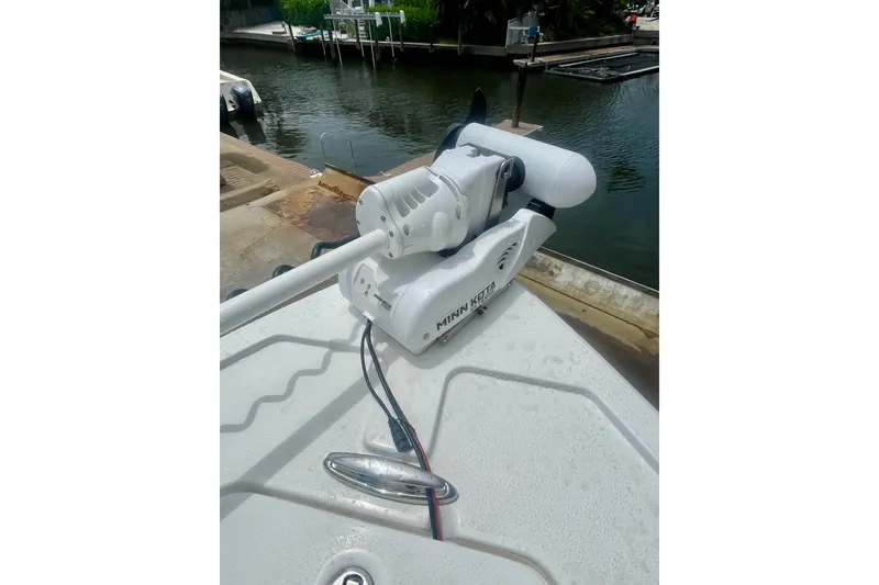 Slide: The Image of Minn Kota trolling motor on 2022 Dorado 25 FD boat docked by the water. - 23