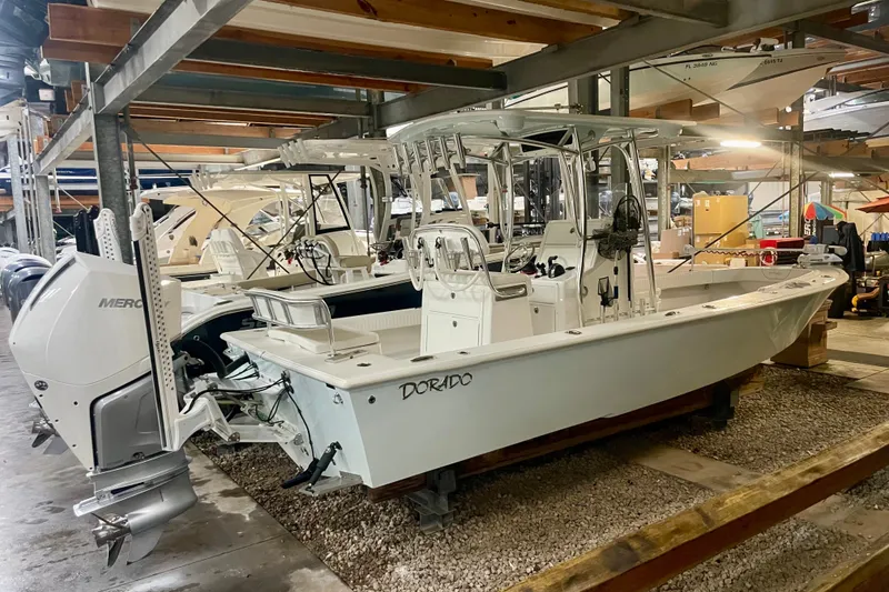 Slide: The Image of 2022 Dorado 25 FD boat in storage, featuring a sleek design and powerful Mercury engine. - 34
