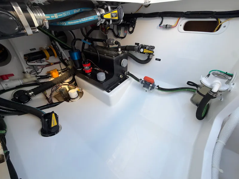 Slide: The Image of The engine room of a 2026 Valhalla V-41 boat with various hoses and equipment. - 30