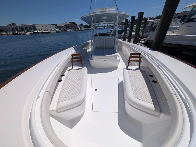 Slide: The Image of The image shows a 2026 Valhalla V-41 boat with sleek white upholstery at a marina. - 26
