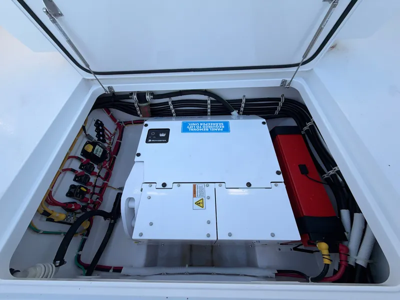 Slide: The Image of An open engine compartment reveals electrical components and wiring in a Valhalla V-41 boat. - 31