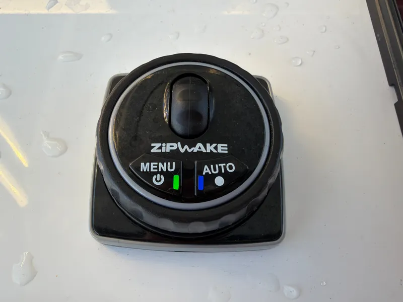 Slide: The Image of A Zipwake control unit with menu and auto options on a boat. - 48
