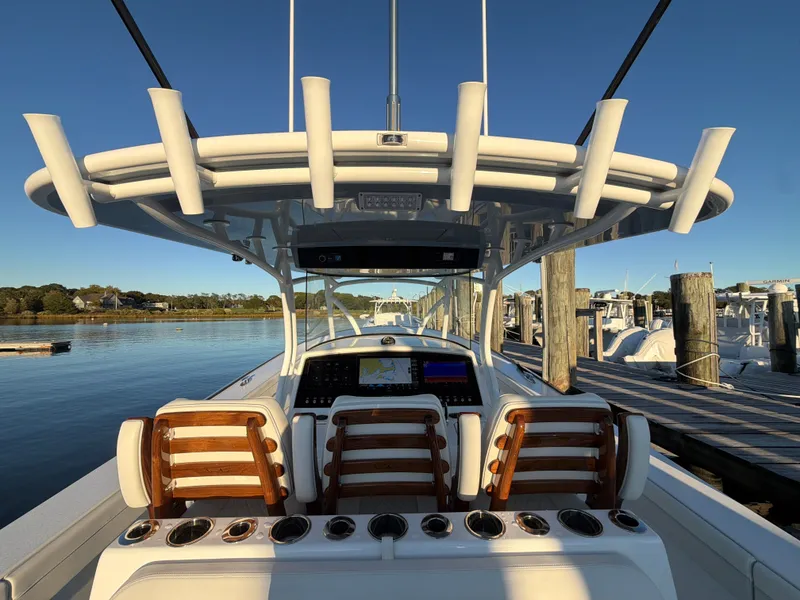 Slide: The Image of The image shows the cockpit of a Valhalla V-41 boat with wooden seats and rod holders. - 37