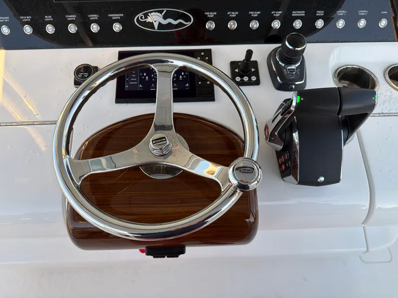 Slide: The Image of The image shows the helm of a Valhalla V-41 boat with a sleek wood finish. - 45
