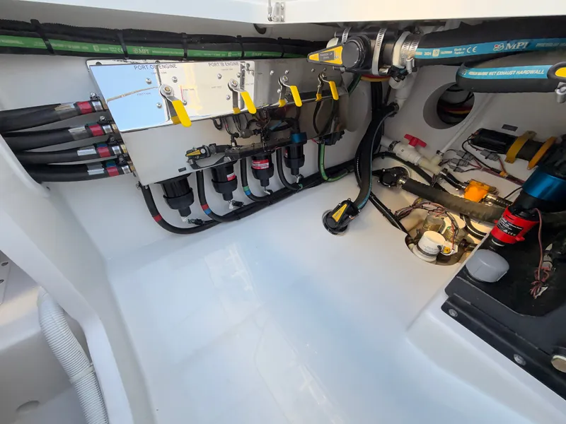 Slide: The Image of The image shows the engine room of a Valhalla V-41 boat with various hoses and valves. - 28