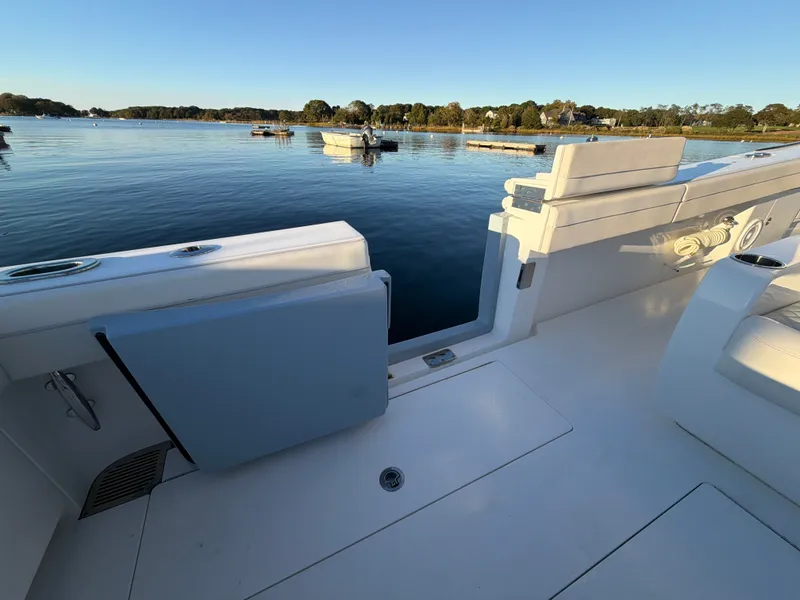 Slide: The Image of The image shows the deck of a Valhalla V-41 boat overlooking calm water and a shoreline. - 34