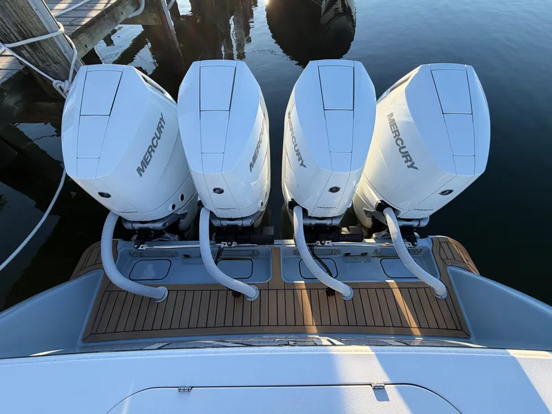 Slide: The Image of Four Mercury outboard engines on a Valhalla V-41 boat, docked at a pier. - 24
