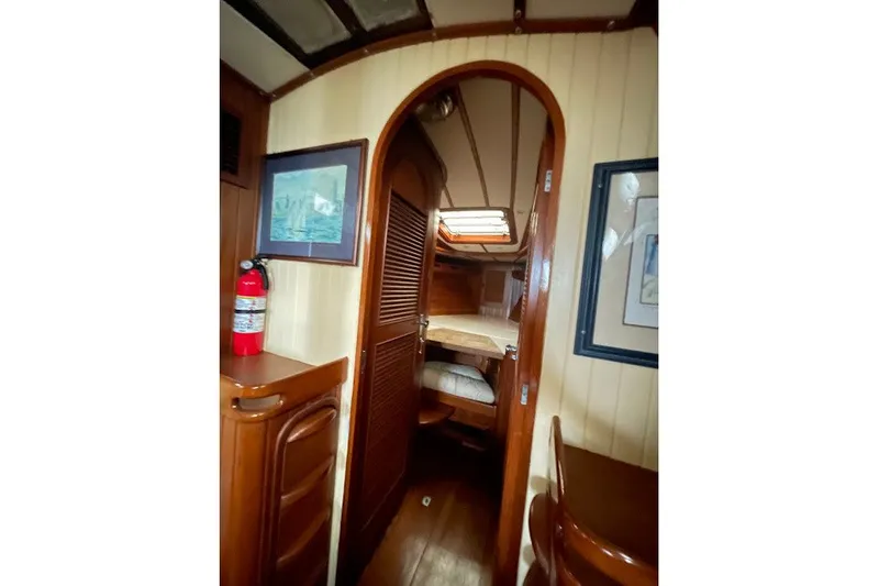 Slide: The Image of 1984 Robert Perry Nassau Tatoosh 42 yacht interior with wooden finish and cozy cabin. - 14