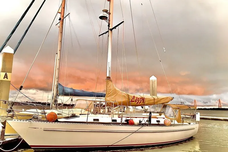 The Image of 1984 Robert Perry Tatoosh 42 sailboat docked at sunset with dramatic sky. - 0
