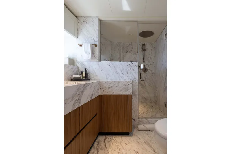 Slide: The Image of Luxurious marble bathroom in 2025 Alpha 100 Squalo yacht, featuring modern fixtures and wooden cabinetry. - 64
