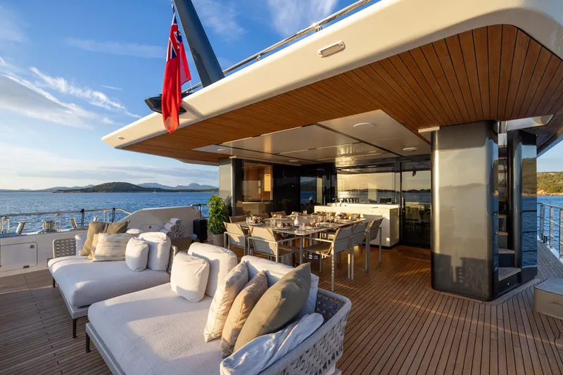 Slide: The Image of Luxurious 2025 Alpha 100 Squalo yacht deck with elegant dining area and plush seating. - 46
