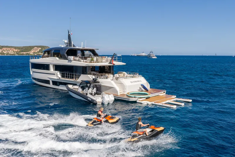 Slide: The Image of Luxury yacht "Alpha 100 Squalo" 2025 model with jet skis on open sea. - 16