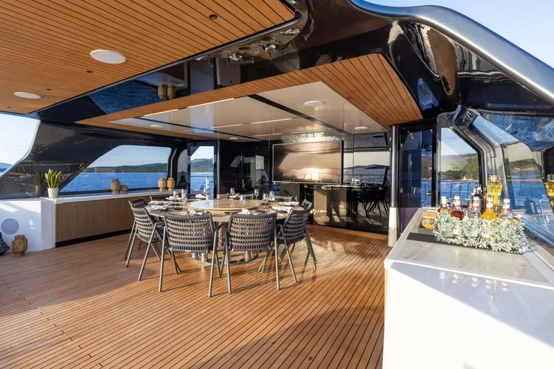 Slide: The Image of Luxurious 2025 Alpha 100 Squalo yacht deck with elegant dining area and scenic ocean view. - 52