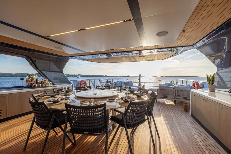 Slide: The Image of Luxurious 2025 Alpha 100 Squalo yacht deck with elegant dining setup and ocean view. - 51