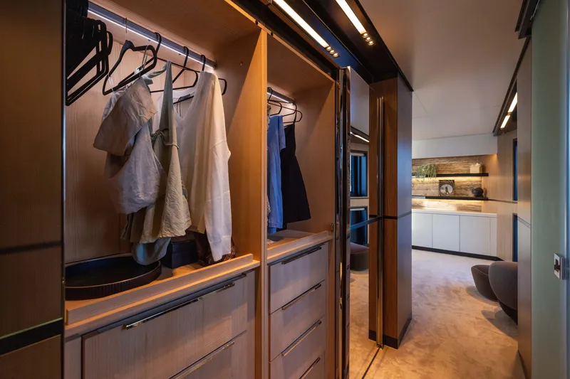 Slide: The Image of Luxurious walk-in closet on the 2025 Alpha 100 Squalo yacht, featuring elegant wooden finishes. - 44
