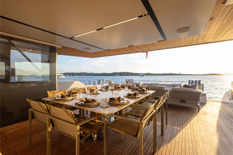 Slide: The Image of Luxurious dining area on 2025 Alpha 100 Squalo yacht with ocean view at sunset. - 18