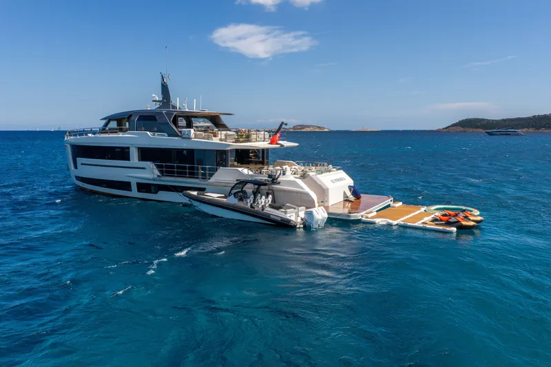Slide: The Image of Luxury yacht Alpha 100 Squalo 2025 anchored in clear blue sea with water toys. - 15