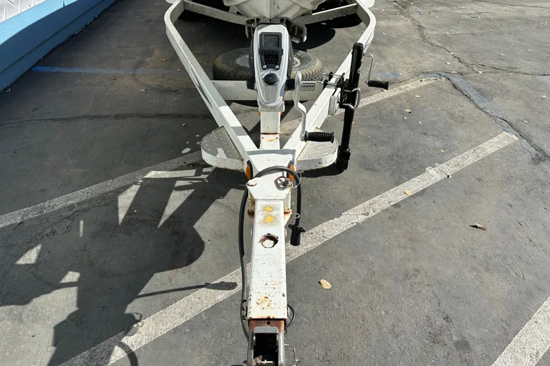 Slide: The Image of Trailer hitch of a 2006 Triton TR-21 boat on a concrete surface. - 3