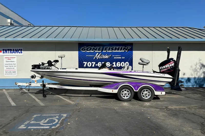 Slide: The Image of 2006 Triton TR-21 boat with trailer parked outside Gone Fishin' Marine store. - 1