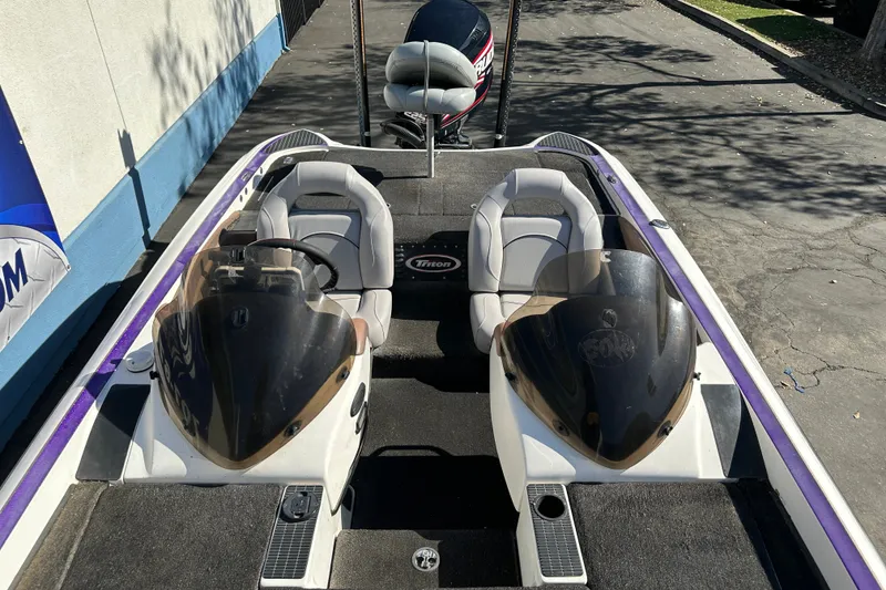 Slide: The Image of 2006 Triton TR-21 boat interior with dual seats and steering console. - 12