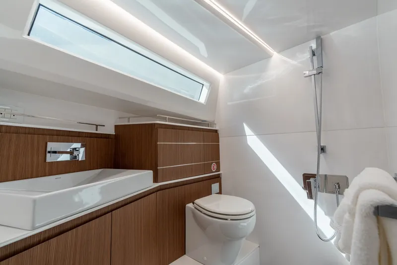 Slide: The Image of Luxurious bathroom in 2023 Evo Yachts R4 WA, featuring modern fixtures and elegant wood accents. - 30