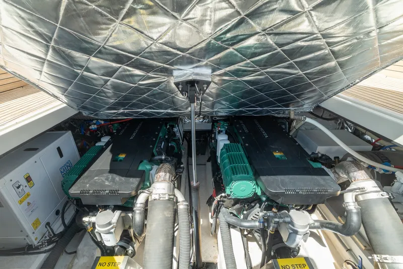 Slide: The Image of Engine compartment of 2023 Evo Yachts R4 WA, showcasing dual engines and mechanical components. - 52