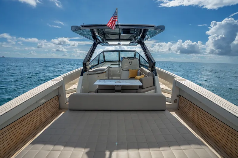 Slide: The Image of 2023 Evo Yachts R4 WA luxury yacht on open sea under blue sky. - 41