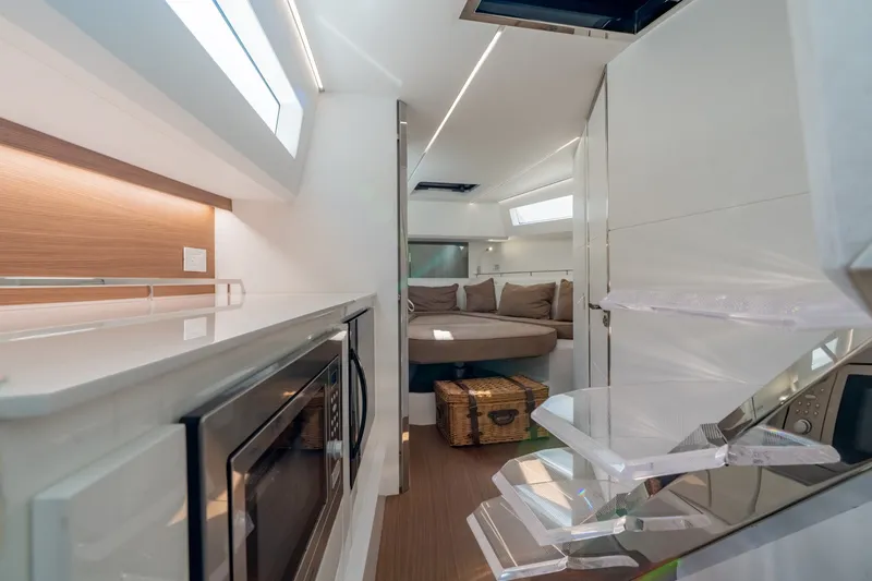 Slide: The Image of Luxurious interior of 2023 Evo Yachts R4 WA, featuring modern kitchen and cozy seating area. - 34