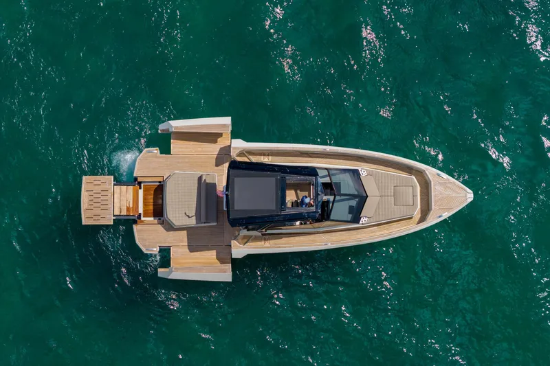 Slide: The Image of Aerial view of 2023 Evo Yachts R4 WA luxury yacht on turquoise water. - 16
