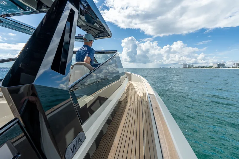 Slide: The Image of 2023 Evo Yachts R4 WA cruising on open water under a partly cloudy sky. - 40