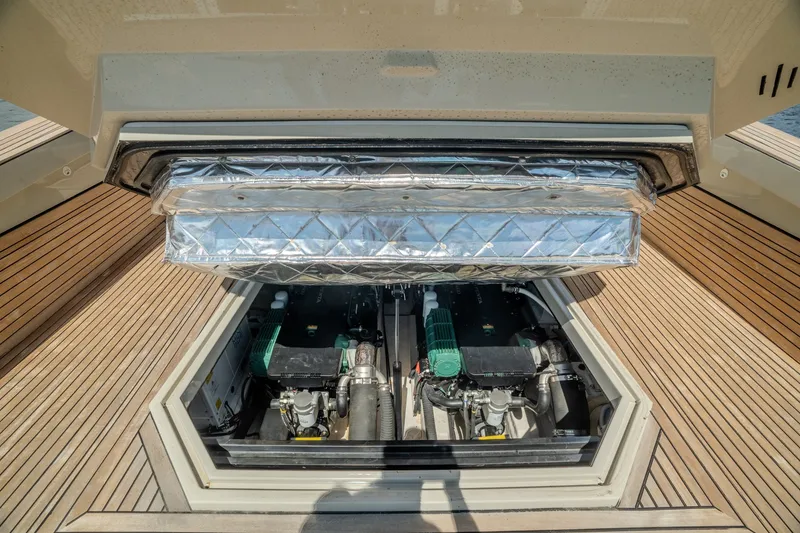 Slide: The Image of Engine compartment of 2023 Evo Yachts R4 WA, showcasing dual engines and teak decking. - 51