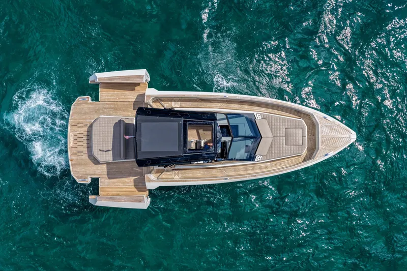 Slide: The Image of 2023 Evo Yachts R4 WA cruising on clear blue water, aerial view. - 10
